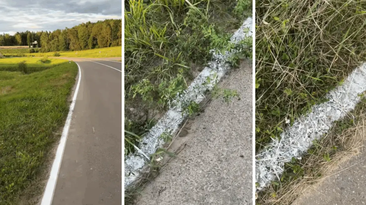 Белая дорожная линия, нанесённая не только на асфальт, но и на обочину: по траве, земле и песку.